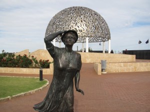 A woman looks out to sea for the lost souls 