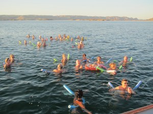 A jolly time in the water with the drinks floating on a lifebuoy.